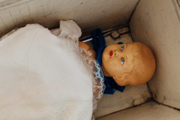 old baby doll in cradle