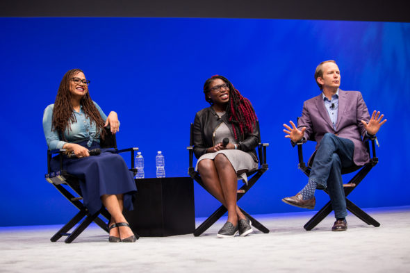 Filmmakers Ava Duvernay and Bola Ogun sitting on stage with At&T Mobility CMO David Christopher