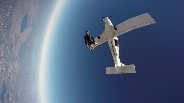 man skydives from plane