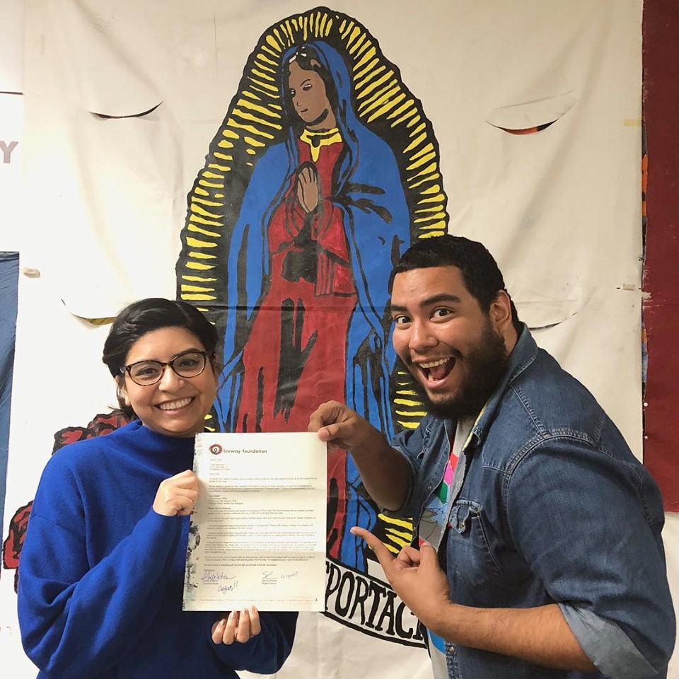 author and community partner holding acceptance letter